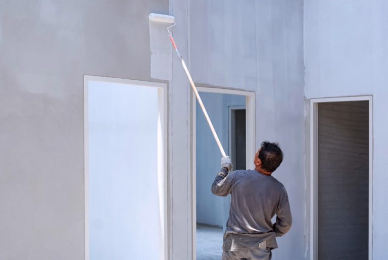 asian-builder-painting-primer-white-color-concrete-wall-inside-house-construction-site