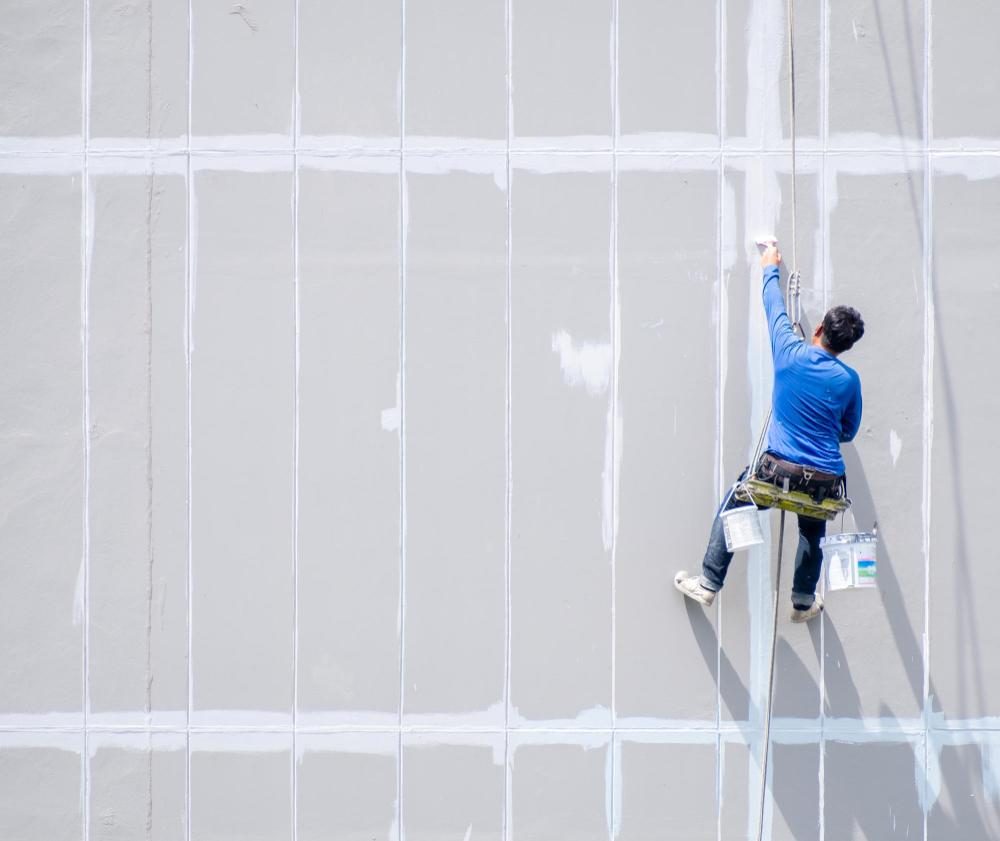 male-painter-is-using-rappelling-rope-paint-tall-buildings-specialized-work-where-danger