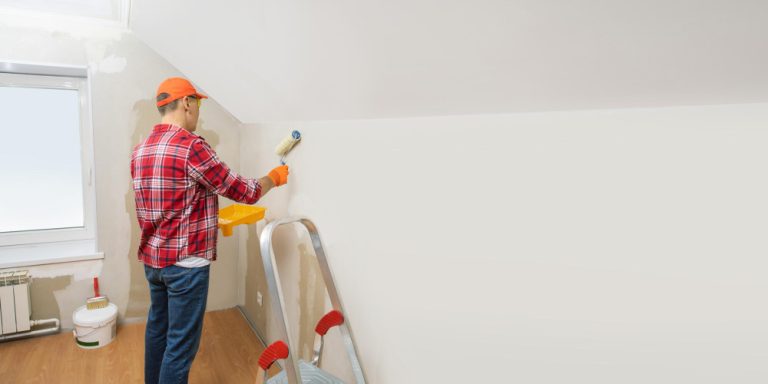 man-paints-wall-house-with-roller-horizontal-banner-with-copy-space