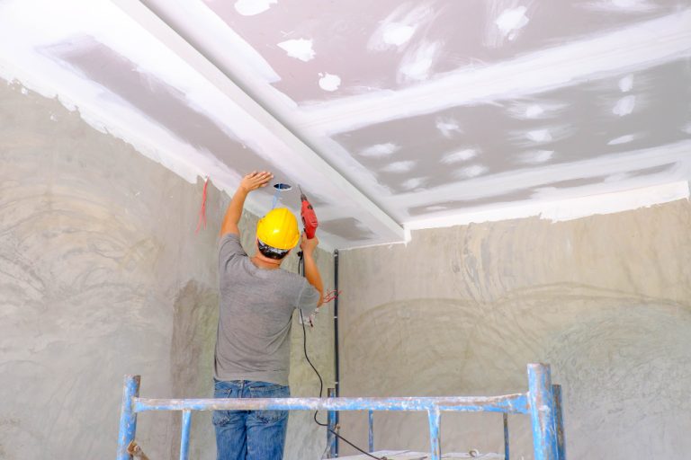 worker-installing-board-ceiling